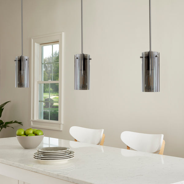 Modern pendant light with smoked glass shade hanging in the dining room